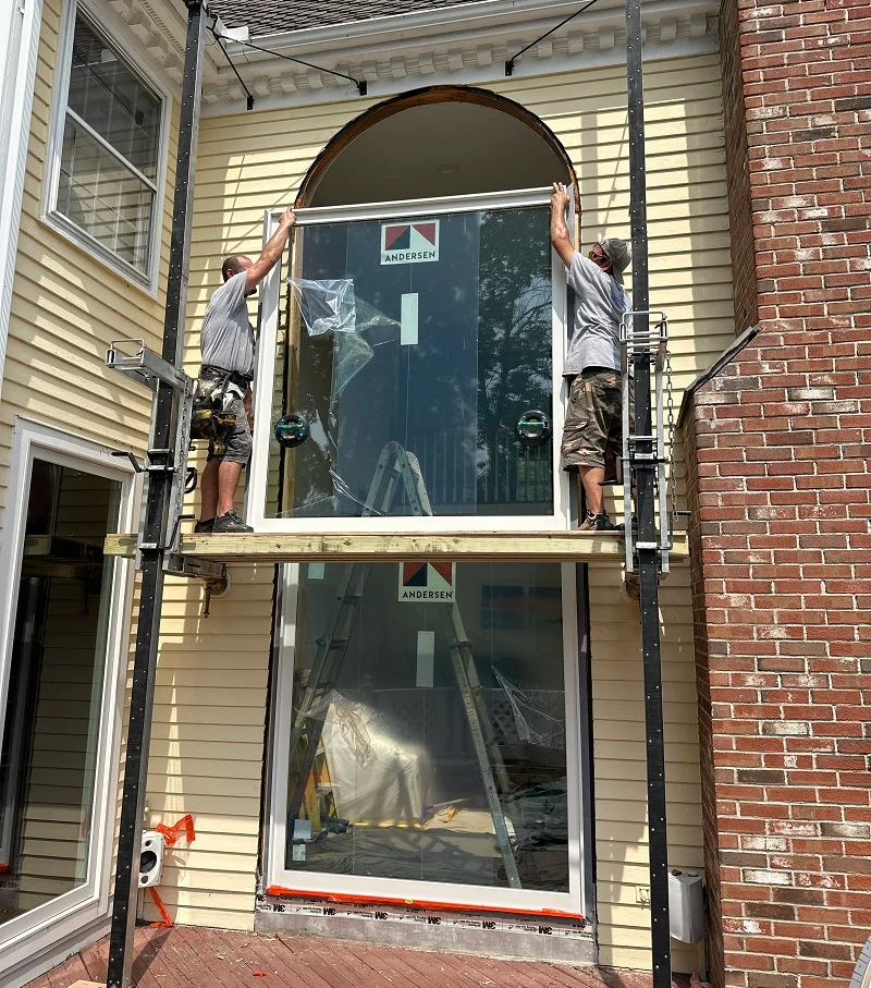 Hoisting these large Andersen windows into place
